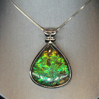 Whole piece of Canadian ammolite stone. Color changing from yellow, green, bluish green to blue, high flash coloration.